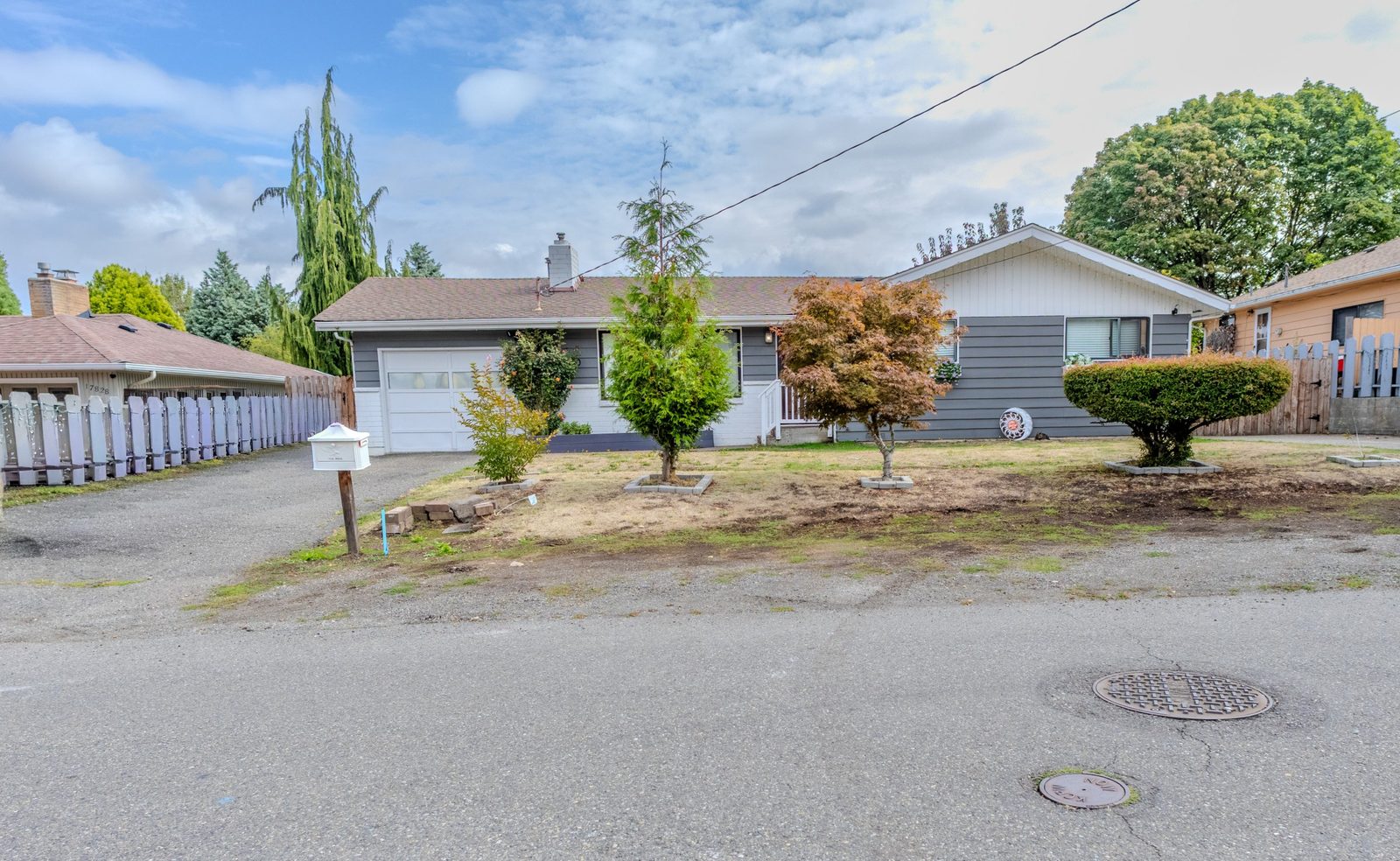 Gray single-story home with garage, seen from the street